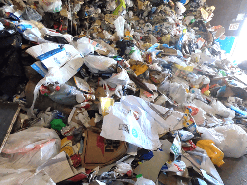 Figure 1 Some materials, like greasy pizza boxes, cannot be recycled, yet still end up in a recycling center.-1_600w